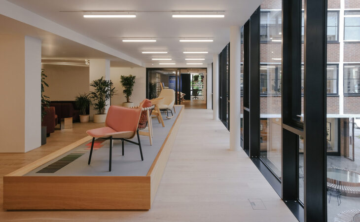 Modern office seating area with large windows.