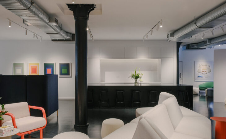Modern office lounge with sofas and art.