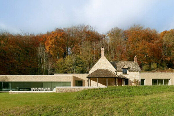 Modern countryside house with autumn trees background.