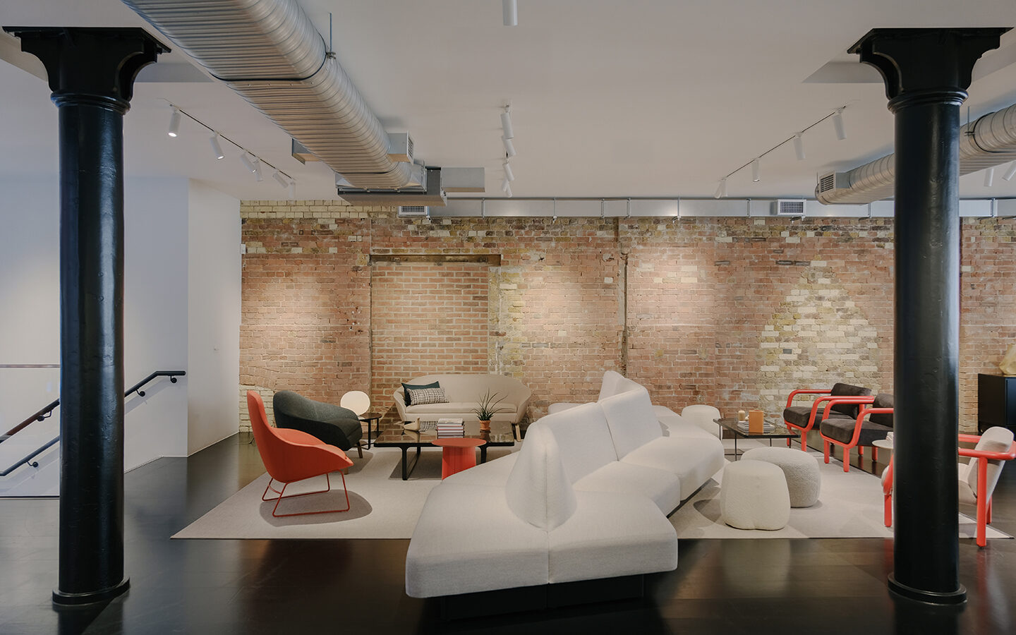 Modern lounge with exposed brick and contemporary furniture.