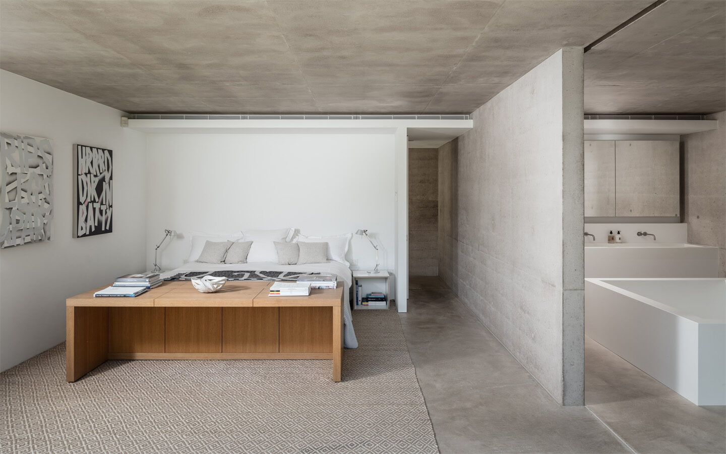 Modern minimalist bedroom with ensuite bathroom.