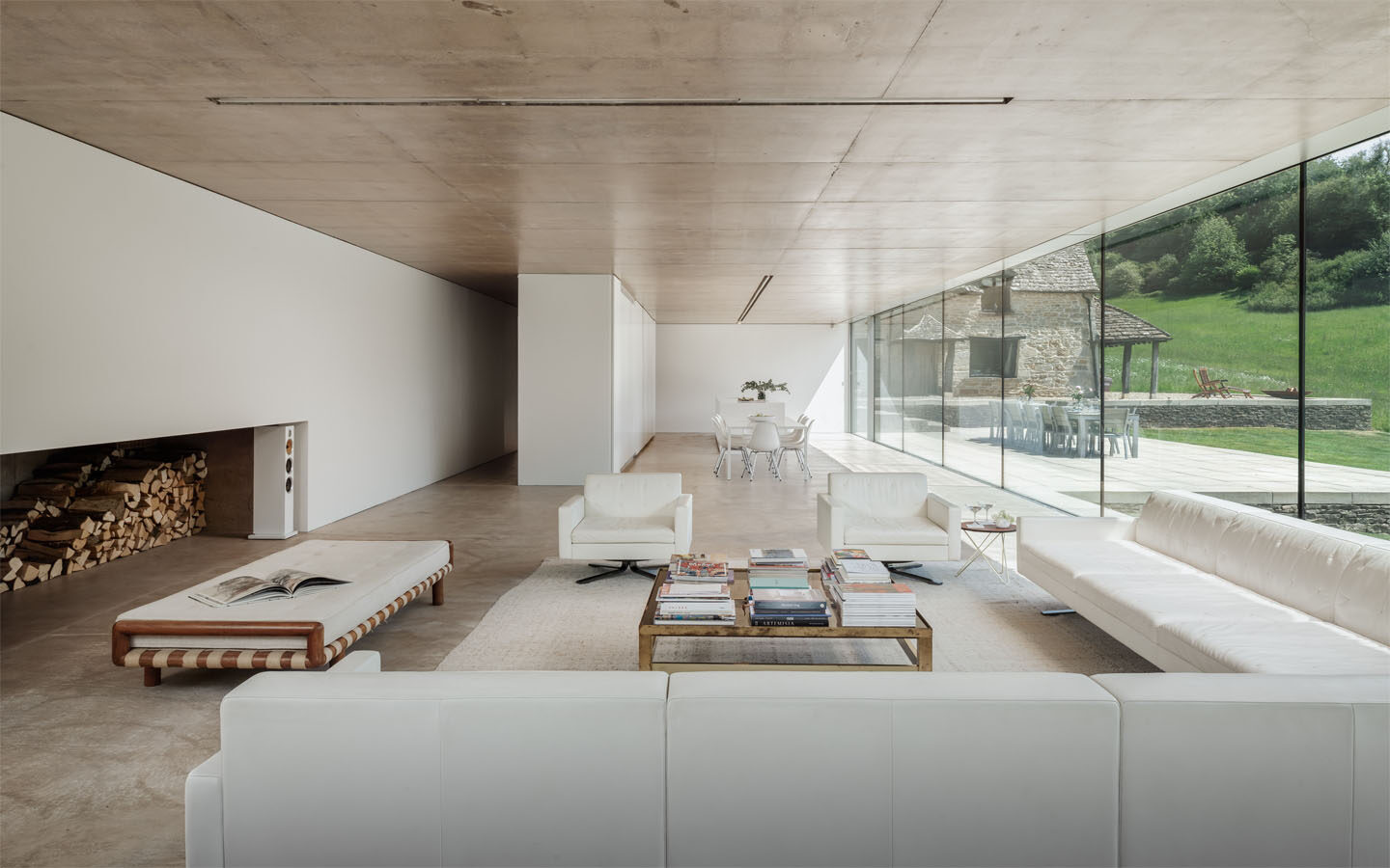Modern living area with large glass windows and countryside view.