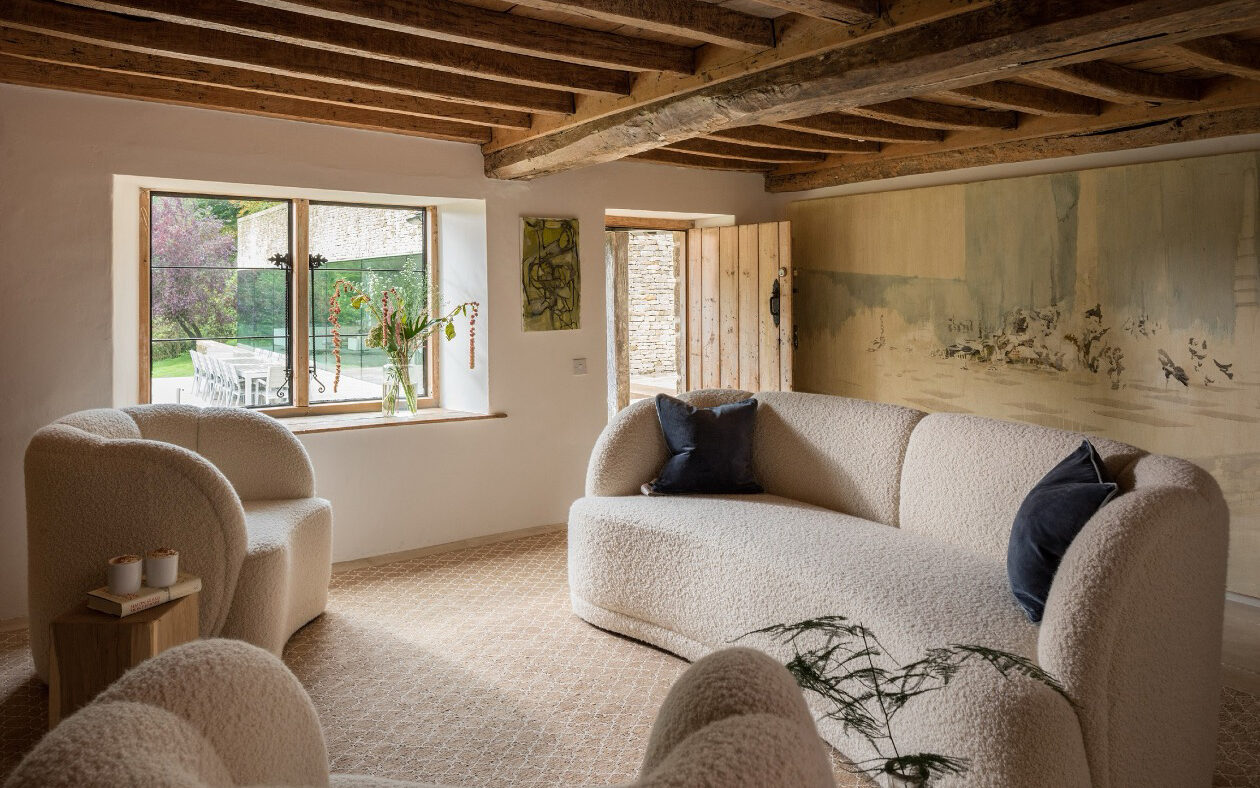 Rustic living room with wooden beams and cosy furniture.