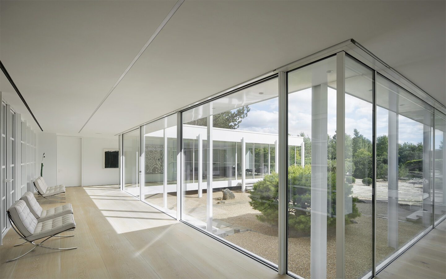 Modern glass corridor with garden view