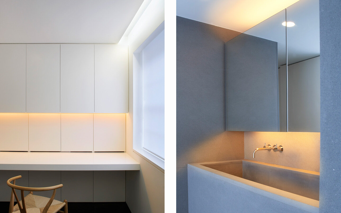 Minimalist kitchen with warm lighting and grey sink.