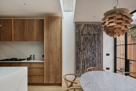 Modern kitchen with wood cabinets and unique lighting