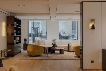 Modern living room with contemporary decor and large windows.