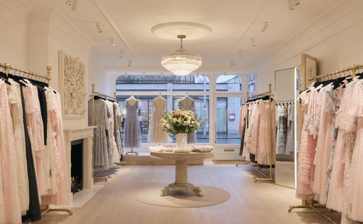 Elegant dress shop with pastel gowns on display.