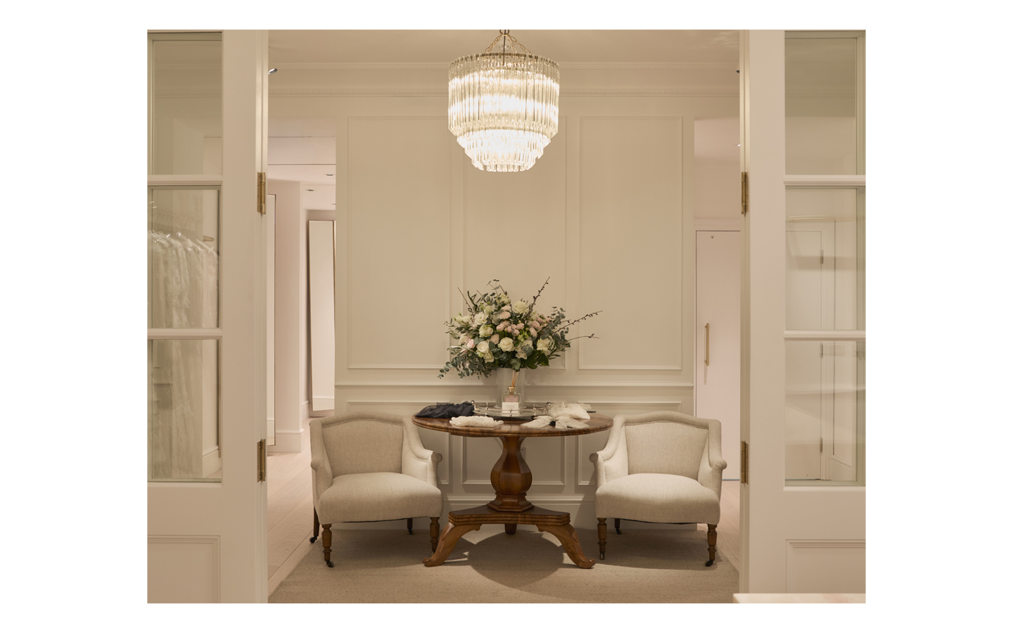 Elegant room with chairs and floral arrangement.