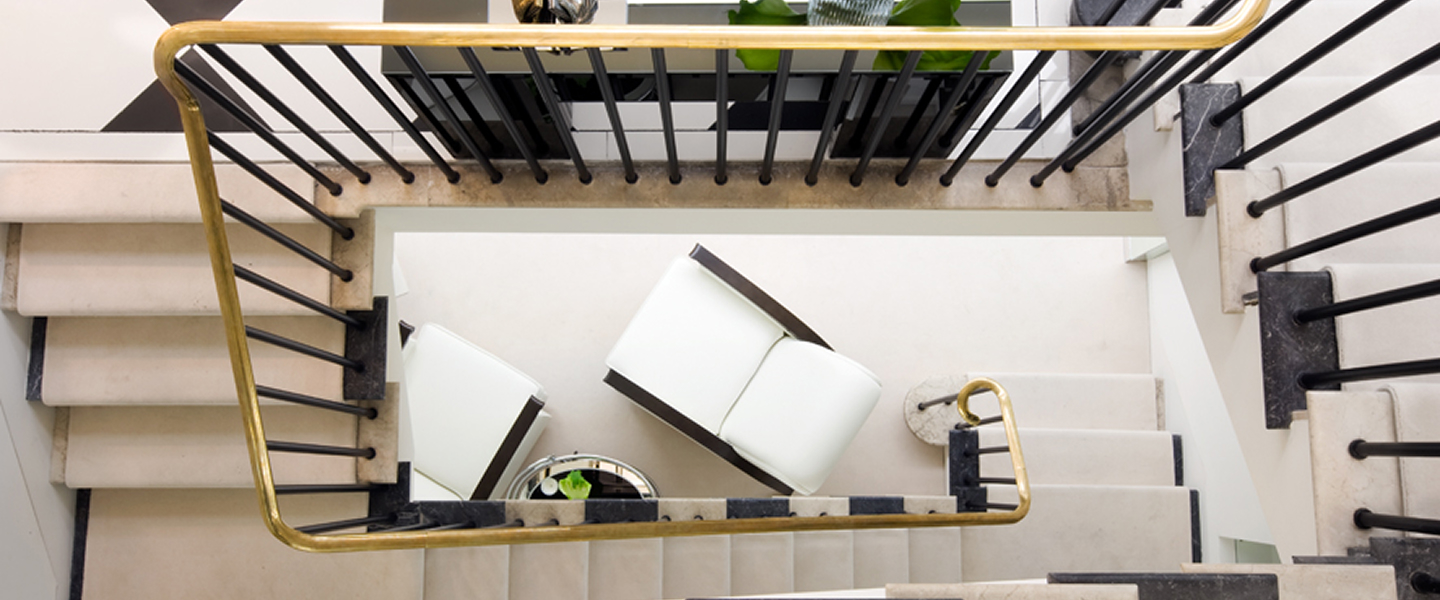 View of modern staircase from above with chairs.